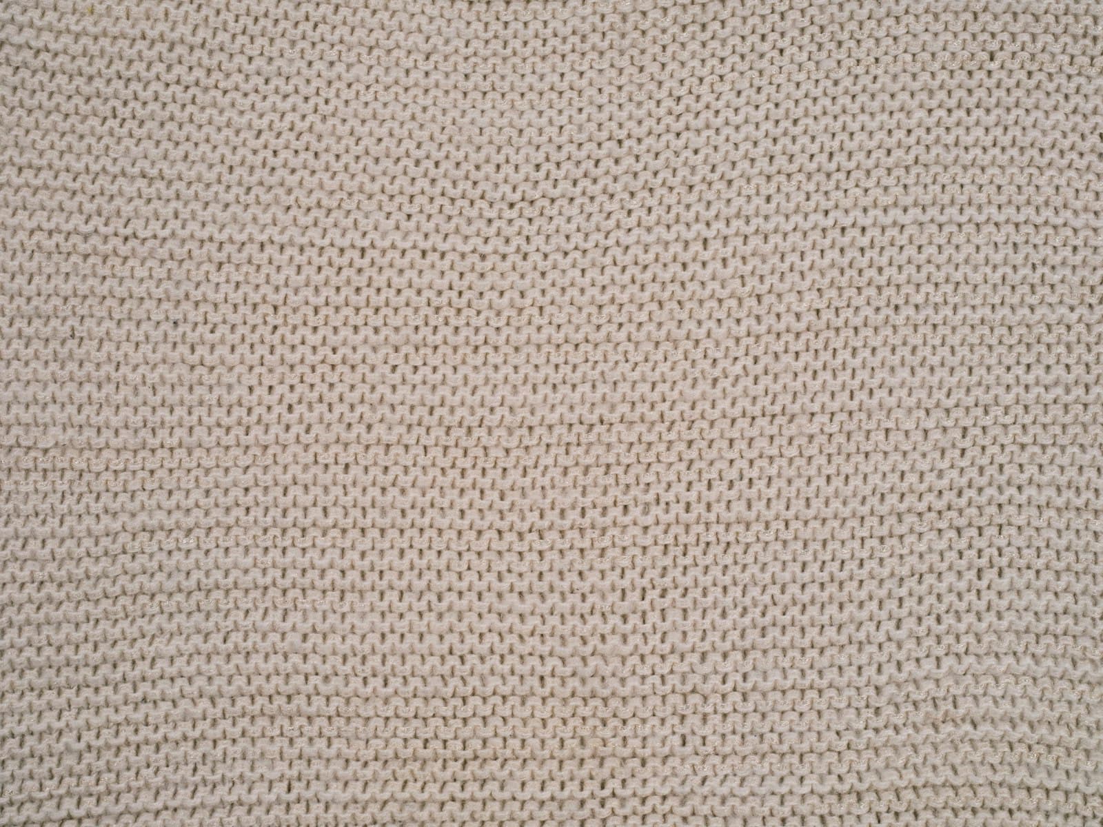 Close-up of an ivory knitted upholstery fabric texture
