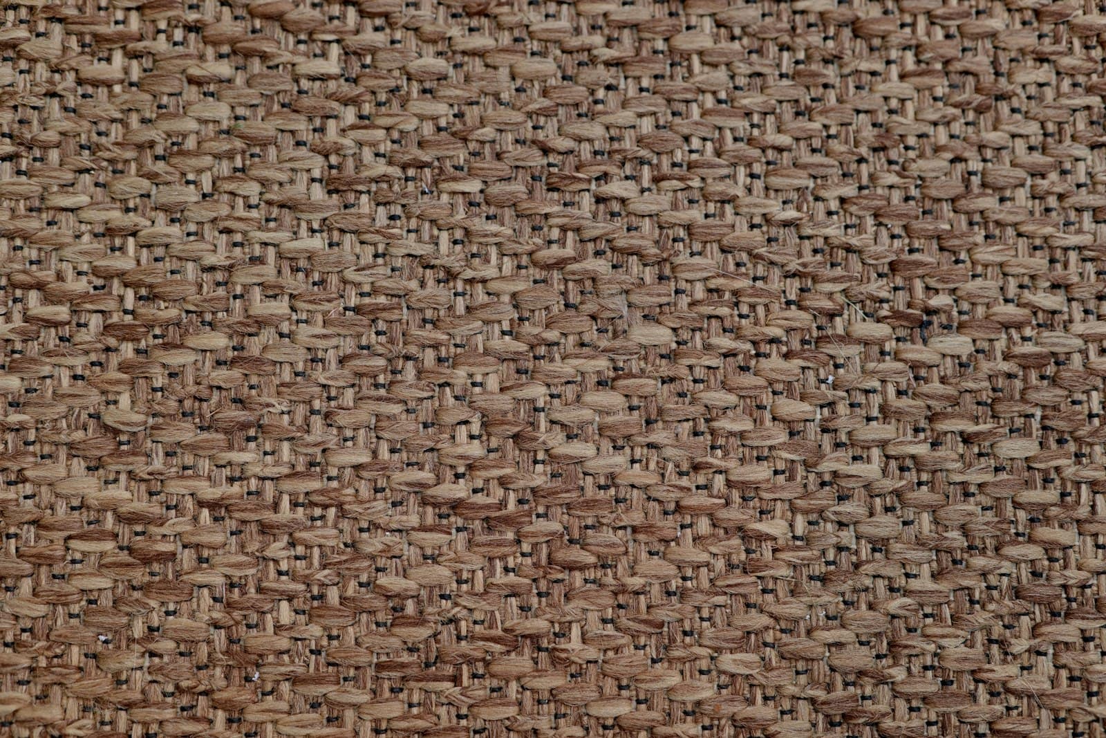 Close-up of a rust-toned woven upholstery fabric