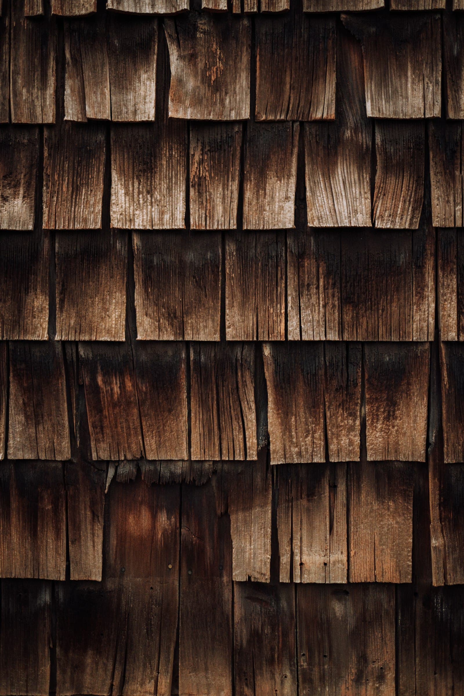 Close-up of a weathered wood shingle wall