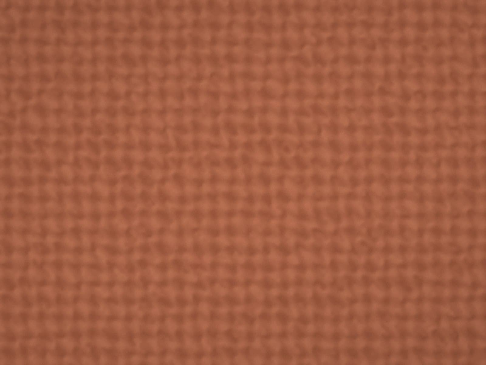 Close-up of a woven upholstery fabric in rust