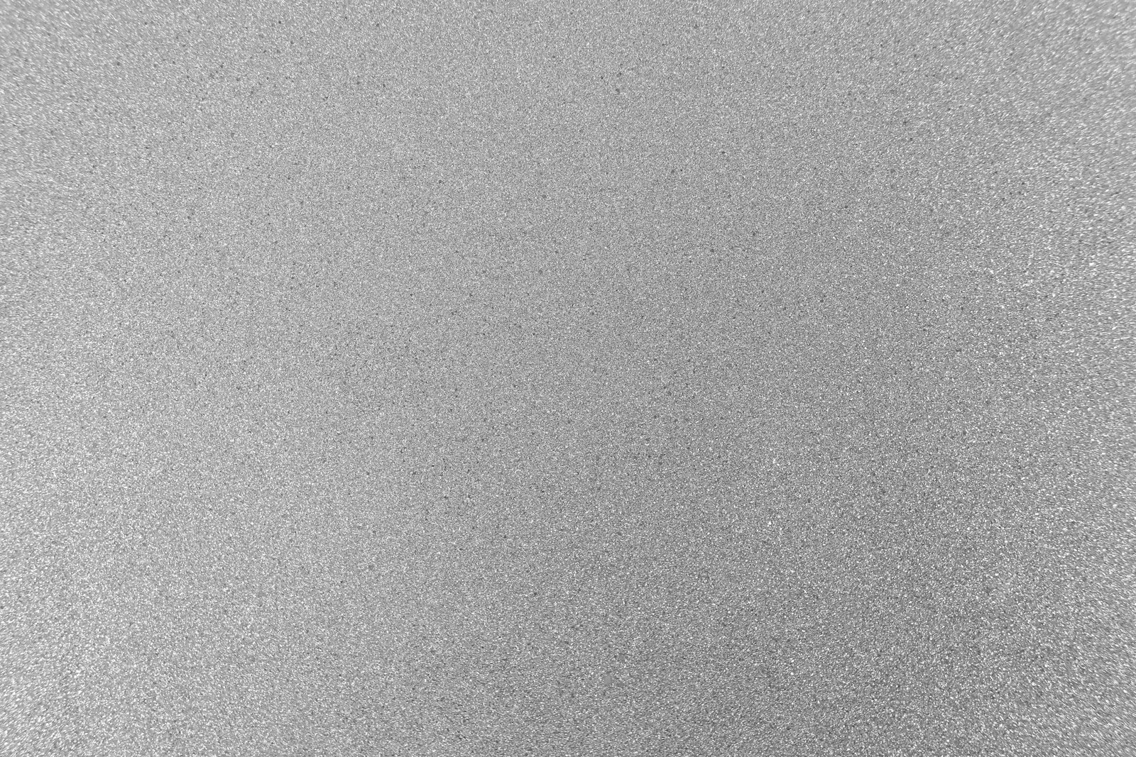 Close-up of a pewter-toned mica wall covering catching light
